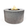 The Outdoor Plus 42" Chat Height Florence Concrete Gas Fire Pit in rustic gray features a distinctive cracked texture that gives it a weathered and natural look. This fire pit is a perfect fit for rustic outdoor environments, adding character and charm.