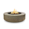 The Outdoor Plus 42" Occasional Height Florence Gas Fire Pit in a rustic Moss Stone finish. This round fire pit features a wide, low-profile design with a durable concrete construction and a natural stone texture, ideal for outdoor spaces. Equipped with a smooth-burning gas system, it provides warmth and ambiance with a modern aesthetic.
