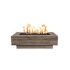 The Outdoor Plus 48-inch Coronado Wood Grain Concrete Gas Fire Pit in oak, highlighting a medium wood tone with realistic grain patterns. This fire pit has a natural oak finish that blends seamlessly into any outdoor environment, providing a rustic and inviting look. The rectangular design and detailed wood grain make it a stylish focal point for patios or backyards, whether used with natural gas or propane. Perfect for creating a cozy outdoor gathering spot.