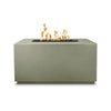 The Outdoor Plus 48-inch Pismo Concrete Gas Fire Pit in ash finish, showcasing a sleek and minimalist rectangular design. This premium concrete fire pit features a center rectangular burner filled with black lava rock and an extended flame pattern, creating a warm and inviting atmosphere for any outdoor space. Ideal for contemporary patio settings, this luxury fire pit offers both functionality and style for modern backyard aesthetics. 