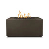 The Outdoor Plus 48-inch Pismo Concrete Gas Fire Pit in chocolate finish, showcasing a deep and rich color that adds a sophisticated touch to outdoor areas. This rectangular concrete fire pit includes a center burner filled with black lava rock, enhancing the visual appeal of the flickering flames. A durable and stylish choice for those looking to create an inviting atmosphere in their backyard. 
