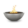 The Outdoor Plus 48" Sedona Concrete Gas Fire Pit with a sleek, round bowl design in a metallic silver finish. This modern silver fire pit adds a touch of luxury and sophistication to any outdoor space. Its durable concrete construction is perfect for use with natural gas or propane, providing versatility and strength. The bowl’s large interior is designed to hold fire glass, lava rocks, or other fire media, making it an ideal centerpiece for contemporary patio settings, poolside areas, or upscale gardens.