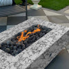 The Outdoor Plus 60-inch Del Mar Concrete Gas Fire Pit in rustic white with a marbled appearance, adding a touch of elegance to outdoor settings. This gas fire pit combines a sleek design with captivating flames over black lava stones, ideal for upscale patios or garden fire features. Luxury fire pit for modern outdoor decor.