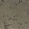 Close-up swatch of The Outdoor Plus 96-inch Del Mar Concrete Gas Fire Pit in Moss Stone. This textured surface showcases a natural stone appearance, perfect for outdoor fire pits, adding rustic and earthy tones to your backyard fire pit setup.