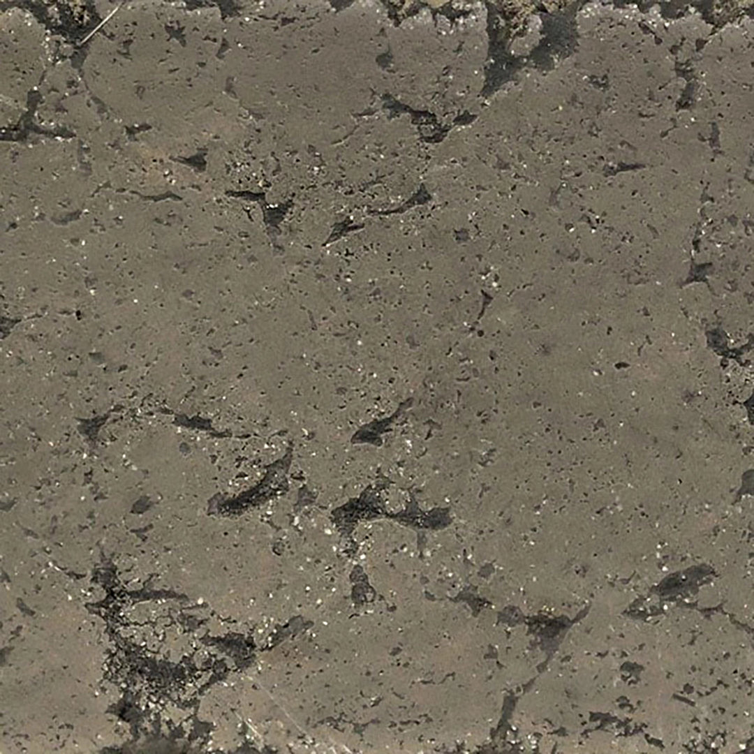 Close-up swatch of The Outdoor Plus 96-inch Del Mar Concrete Gas Fire Pit in Moss Stone. This textured surface showcases a natural stone appearance, perfect for outdoor fire pits, adding rustic and earthy tones to your backyard fire pit setup.
