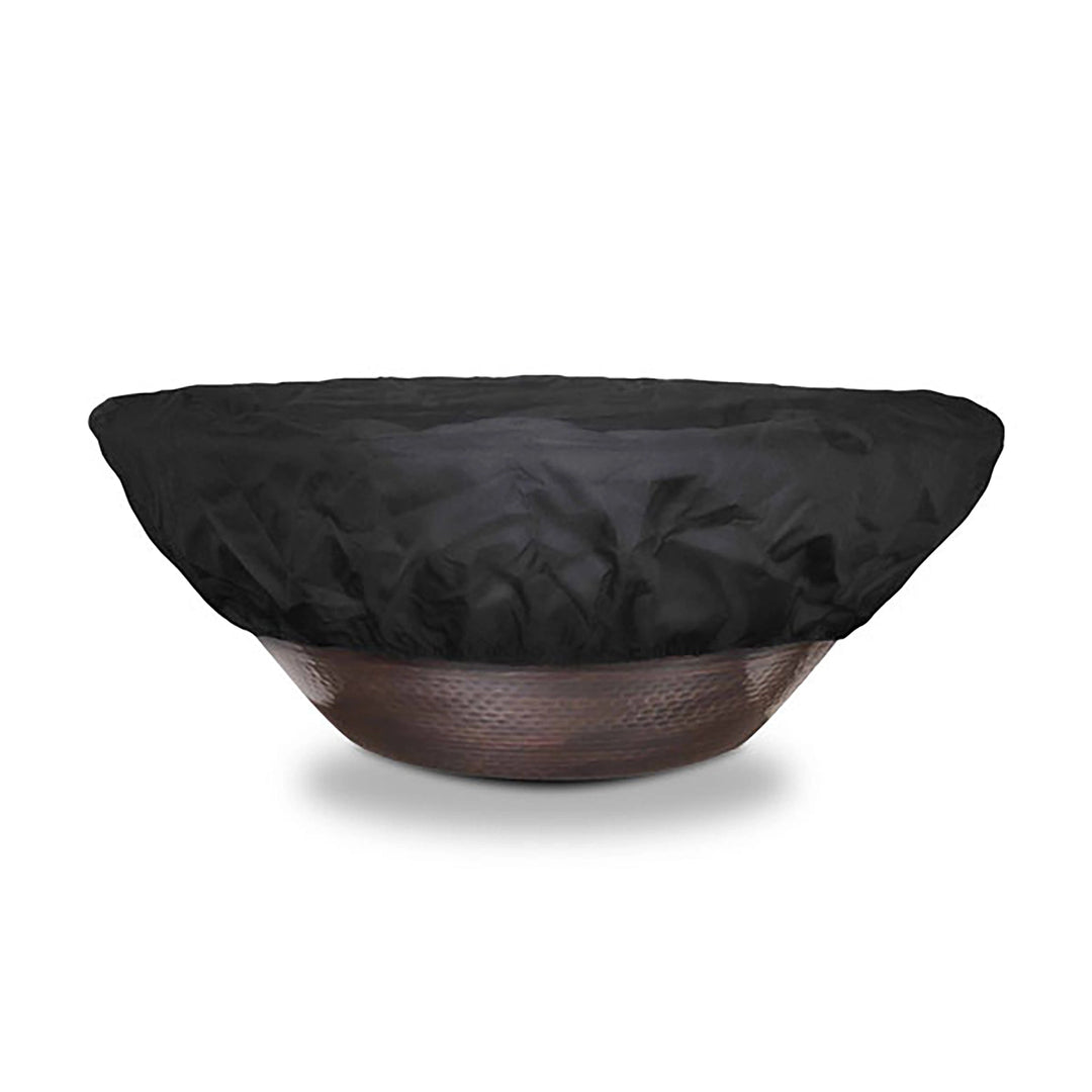 Front view of The Outdoor Plus round bowl fire pit cover fully covering a medium-sized fire bowl. This durable cover features a form-fitting design with reinforced stitching, providing all-around protection from rain, wind, and debris. The high-quality black fabric material is suitable for year-round outdoor use, ensuring your fire pit stays in top condition.