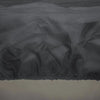 Close-up image of "The Outdoor Plus Round Firepit Cover" featuring a textured, weather-resistant fabric that offers superior protection against harsh outdoor elements. The fabric is waterproof and UV-resistant, ensuring the fire pit stays clean and dry. This heavy-duty cover is ideal for outdoor fire bowls, round patio fire pits, and backyard fire tables, providing a snug fit for maximum durability and reliability.