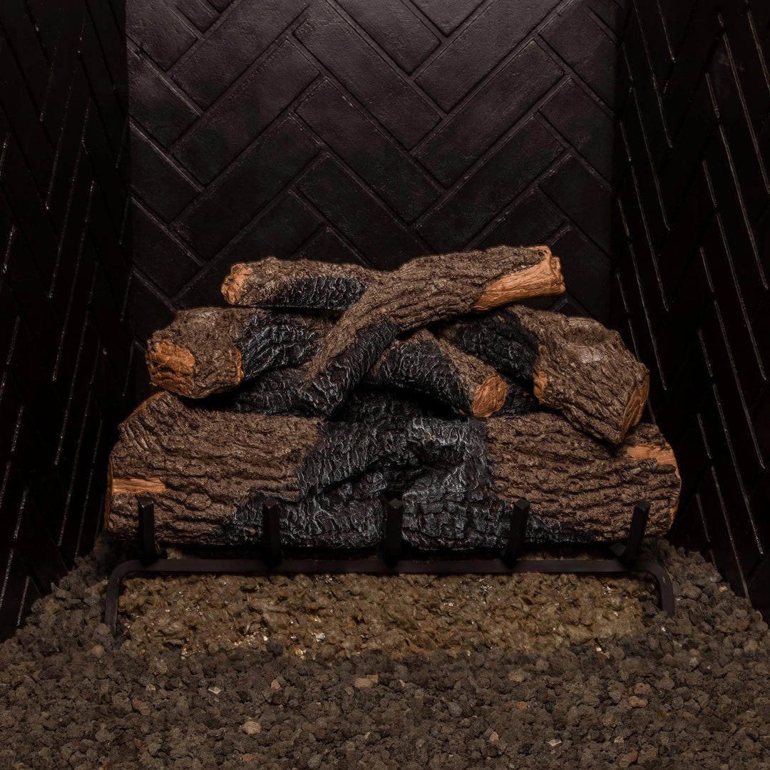 24-inch Real Fyre Vented Charred Oak Gas Logs stacked in a fireplace grate, ready for use without fire. The charred oak finish and realistic wood details provide a natural aesthetic even without flames, perfect for adding rustic charm to any vented gas fireplace.