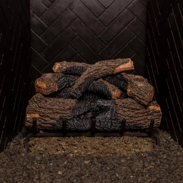 24-inch Real Fyre Vented Charred Oak Gas Logs stacked in a fireplace grate, ready for use without fire. The charred oak finish and realistic wood details provide a natural aesthetic even without flames, perfect for adding rustic charm to any vented gas fireplace.