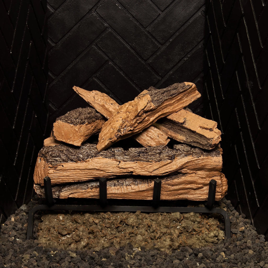 Front view of the Real Fyre Vented Designer Plus Gas Logs in split oak, unlit, arranged on a black grate. The 18-inch log set mimics natural oak wood with realistic texture, featuring dark bark and light wood grain for a rustic and authentic look. Perfect for traditional wood-burning fireplace aesthetics, this set complements gas fireplaces.