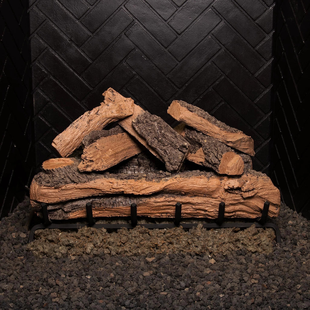 Unlit front view of the Real Fyre Vented Designer Plus Gas Logs in split oak, 30 inches, stacked in a natural formation on a black fireplace grate. This large log set captures the rugged appearance of split oak wood, with intricate bark and exposed wood detailing, offering a lifelike look for gas fireplaces. Ideal for larger fireplaces, it enhances the cozy atmosphere of any living space.