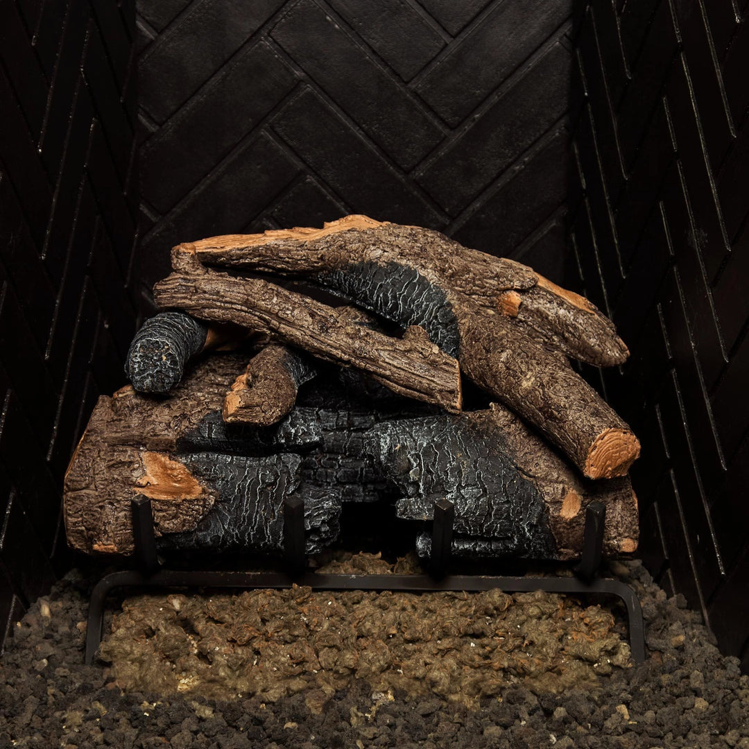 Real Fyre Vented Charred American Oak Gas Logs 18 inch set, meticulously stacked in a fireplace with natural charred detailing and intricate wood grain, creating a highly realistic fire aesthetic. Ideal for vented gas log fireplaces.