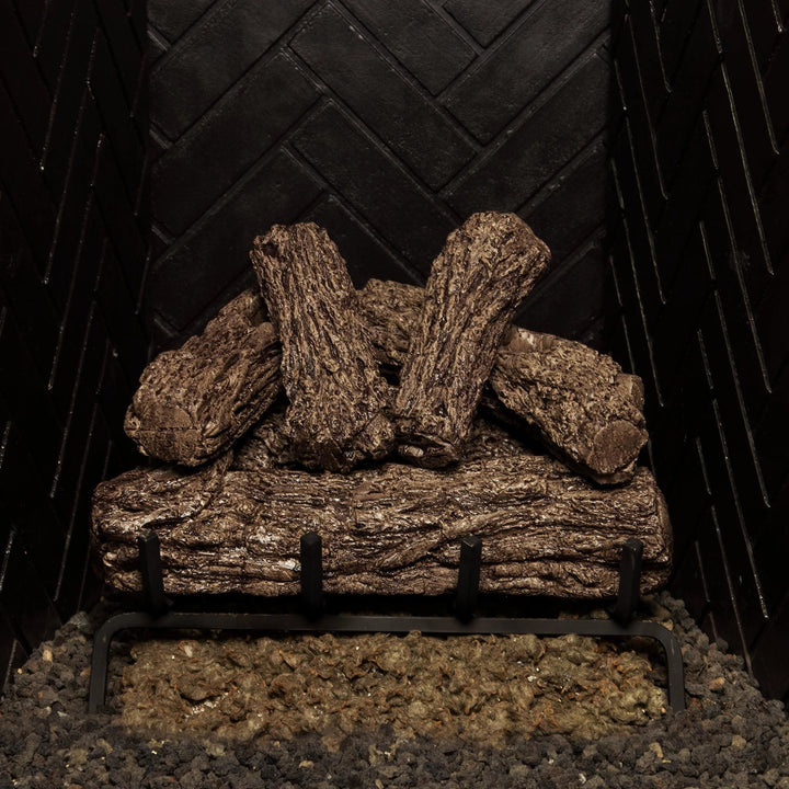 Real Fyre 18-inch Rustic Oak vented gas logs arranged on a black grate. Showcases realistic wood design, ideal for vented natural gas fireplace displays without flames.